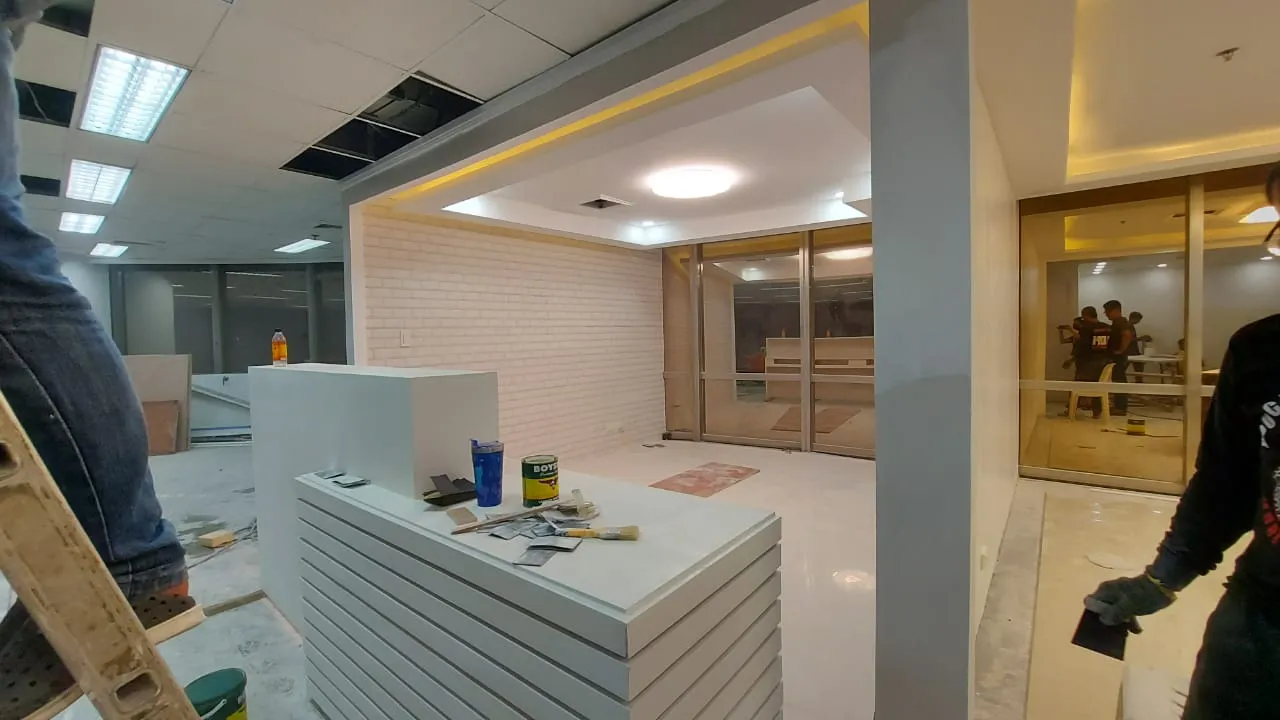 Office under construction with paint cans and debris before Total Cleaning Manila handover cleaning